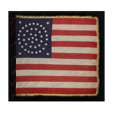 RARE AND EXCEPTIONAL 44 STAR UNITED STATES INFANTRY BATTLE FLAG WITH A MEDALLION CONFIGURATION, GOLD FRINGE, AND RED WOOL TIES, LATE INDIAN WARS, WYOMING STATEHOOD, 1890-1896