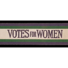 FULL, WRAP-AROUND, SILK SUFFRAGETTE SASH IN GREEN, WHITE, & VIOLET, WITH "VOTES FOR WOMEN" TEXT, DESIGNED BY SYLVIA PANKHURST FOR THE WOMEN’S SOCIAL & POLITICAL UNION (U.K.), LIKELY PRODUCED BY TOYE &. COMPANY OF BIRMINGHAM, circa 1908 AND LIKELY SOLD BY AN AMERICAN-OWNED DEPARTMENT STORE IN THAT SAME CITY, GIFTED TO A BIRMINGHAM ACTIVIST & EDUCATOR