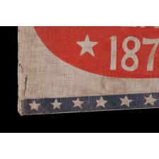 SWALLOW-TAILED PARADE FLAG / PENNANT WITH “1776 CENTENNIAL 1876” SET WITHIN A SUNBURNT, RED-ORANGE, EGG-SHAPED WINDOW, WITHIN A BLUE BORDER WITH 37 STARS; AN EXTREMELY RARE EXAMPLE, MADE TO CELEBRATE THE 100-YEAR ANNIVERSARY OF AMERICAN INDEPENDENCE