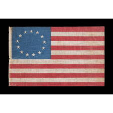 13 STAR ANTIQUE AMERICAN PARADE FLAG WITH A SINGLE WREATH OF STARS REMINISCENT OF THE BETSY ROSS PATTERN, BUT RENDERED AS MORE OF AN OVAL, THE ONLY EXAMPLE OF THIS EXACT VARIETY THAT I HAVE EVER ENCOUNTERED, MADE circa 1890-WWI (U.S. INVOLVEMENT 1917-18)