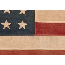 48 STAR ANTIQUE AMERICAN FLAG OF THE 1912-1918 ERA, LIKELY A U.S. NAVY SMALL BOAT ENSIGN, PRODUCED FOR U.S. INVOLVEMENT IN WWI (1917-18); THE EARLIEST IDENTIFIED EXAMPLE OF ANY KIND FROM PROMINENT U.S. FLAG-MAKER JOHN C. DETTRA, THE FIRM OF WHICH PRACTICALLY NEVER SIGNED FLAGS UNTIL POST-WWII (1945 & AFTER)