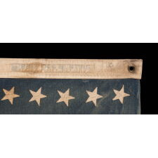 48 STAR ANTIQUE AMERICAN FLAG OF THE 1912-1918 ERA, LIKELY A U.S. NAVY SMALL BOAT ENSIGN, PRODUCED FOR U.S. INVOLVEMENT IN WWI (1917-18); THE EARLIEST IDENTIFIED EXAMPLE OF ANY KIND FROM PROMINENT U.S. FLAG-MAKER JOHN C. DETTRA, THE FIRM OF WHICH PRACTICALLY NEVER SIGNED FLAGS UNTIL POST-WWII (1945 & AFTER)