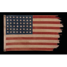 48 STAR ANTIQUE AMERICAN FLAG OF THE 1912-1918 ERA, LIKELY A U.S. NAVY SMALL BOAT ENSIGN, PRODUCED FOR U.S. INVOLVEMENT IN WWI (1917-18); THE EARLIEST IDENTIFIED EXAMPLE OF ANY KIND FROM PROMINENT U.S. FLAG-MAKER JOHN C. DETTRA, THE FIRM OF WHICH PRACTICALLY NEVER SIGNED FLAGS UNTIL POST-WWII (1945 & AFTER)