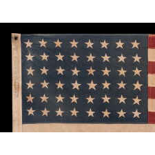 48 STAR ANTIQUE AMERICAN FLAG OF THE 1912-1918 ERA, LIKELY A U.S. NAVY SMALL BOAT ENSIGN, PRODUCED FOR U.S. INVOLVEMENT IN WWI (1917-18); THE EARLIEST IDENTIFIED EXAMPLE OF ANY KIND FROM PROMINENT U.S. FLAG-MAKER JOHN C. DETTRA, THE FIRM OF WHICH PRACTICALLY NEVER SIGNED FLAGS UNTIL POST-WWII (1945 & AFTER)