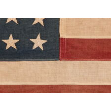 48 STAR ANTIQUE AMERICAN FLAG OF THE 1912-1918 ERA, LIKELY A U.S. NAVY SMALL BOAT ENSIGN, PRODUCED FOR U.S. INVOLVEMENT IN WWI (1917-18); THE EARLIEST IDENTIFIED EXAMPLE OF ANY KIND FROM PROMINENT U.S. FLAG-MAKER JOHN C. DETTRA, THE FIRM OF WHICH PRACTICALLY NEVER SIGNED FLAGS UNTIL POST-WWII (1945 & AFTER)