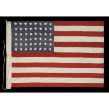 48 STAR AMERICAN NATIONAL FLAG WITH ITS CANTON RESTING ON THE WAR STRIPE, POSSIBLY MADE IN FRANCE DURING WWII TO WELCOME U.S. TROOPS IN THE WAKE OF LIBERATION FROM THE NAZIS, WITH VERBAL HISTORY TO NORMANDY