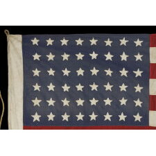 48 STAR AMERICAN NATIONAL FLAG WITH ITS CANTON RESTING ON THE WAR STRIPE, POSSIBLY MADE IN FRANCE DURING WWII TO WELCOME U.S. TROOPS IN THE WAKE OF LIBERATION FROM THE NAZIS, WITH VERBAL HISTORY TO NORMANDY