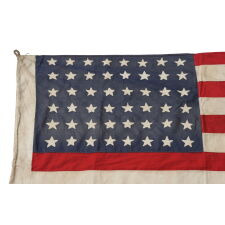 48 STAR AMERICAN NATIONAL FLAG WITH ITS CANTON RESTING ON THE WAR STRIPE, POSSIBLY MADE IN FRANCE DURING WWII TO WELCOME U.S. TROOPS IN THE WAKE OF LIBERATION FROM THE NAZIS, WITH VERBAL HISTORY TO NORMANDY
