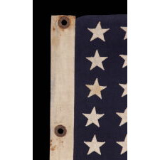AMERICAN FLAG, 48 STARS, A U.S. NAVY SMALL BOAT ENSIGN FROM A WWII SUBMARINE, WITH ENDEARING WEAR FROM LONG-TERM USE; THE FLAG MADE IN JANUARY, 1944 AT MARE ISLAND, CALIFORNIA; BROUGHT HOME BY GUNNER’S MATE 2ND CLASS, JAY J. BURKINS OF LANCASTER COUNTY, PENNSYLVANIA
