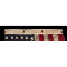 AMERICAN FLAG, 48 STARS, A U.S. NAVY SMALL BOAT ENSIGN FROM A WWII SUBMARINE, WITH ENDEARING WEAR FROM LONG-TERM USE; THE FLAG MADE IN JANUARY, 1944 AT MARE ISLAND, CALIFORNIA; BROUGHT HOME BY GUNNER’S MATE 2ND CLASS, JAY J. BURKINS OF LANCASTER COUNTY, PENNSYLVANIA