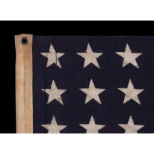 ANTIQUE AMERICAN FLAG WITH 48 STARS, A U.S. NAVY SMALL BOAT ENSIGN, MADE IN JANUARY OF 1944, DURING WWII (U.S. INVOLVEMENT 1941-45), AT MARE ISLAND, CALIFORNIA, FORMER HEADQUARTERS OF THE PACIFIC FLEET, WITH ENDEARING WEAR FROM LONG-TERM USE