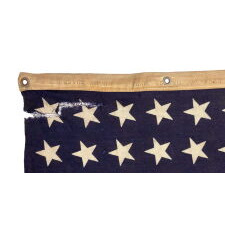 ANTIQUE AMERICAN FLAG WITH 48 STARS, A U.S. NAVY SMALL BOAT ENSIGN, MADE IN JANUARY OF 1944, DURING WWII (U.S. INVOLVEMENT 1941-45), AT MARE ISLAND, CALIFORNIA, FORMER HEADQUARTERS OF THE PACIFIC FLEET, WITH ENDEARING WEAR FROM LONG-TERM USE