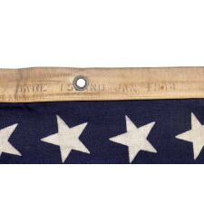 ANTIQUE AMERICAN FLAG WITH 48 STARS, A U.S. NAVY SMALL BOAT ENSIGN, MADE IN JANUARY OF 1944, DURING WWII (U.S. INVOLVEMENT 1941-45), AT MARE ISLAND, CALIFORNIA, FORMER HEADQUARTERS OF THE PACIFIC FLEET, WITH ENDEARING WEAR FROM LONG-TERM USE