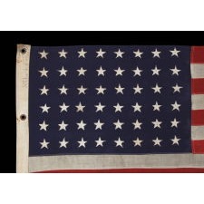 WWII VINTAGE ANTIQUE AMERICAN FLAG WITH 48 STARS AND ENDEARING WEAR FROM OBVIOUS LONG-TERM USE, A U.S. NAVY SMALL BOAT ENSIGN MARKED "No. 11"