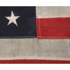 WWII VINTAGE ANTIQUE AMERICAN FLAG WITH 48 STARS AND ENDEARING WEAR FROM OBVIOUS LONG-TERM USE, A U.S. NAVY SMALL BOAT ENSIGN MARKED "No. 11"